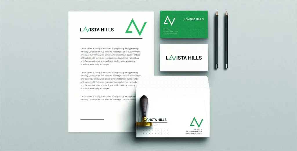 Set of branded stationery items for La Vista Hills, including a letterhead, business cards, an envelope, a stamp, and two pens. The branding features a green and white color scheme with the 'La Vista Hills' logo and a stylized 'LV' symbol. The letterhead contains a block of text, the business card has the 'LV' logo and company name with contact information, and the envelope also features the logo and company name. The stamp is used for branding purposes, and the pens are plain with no visible branding.